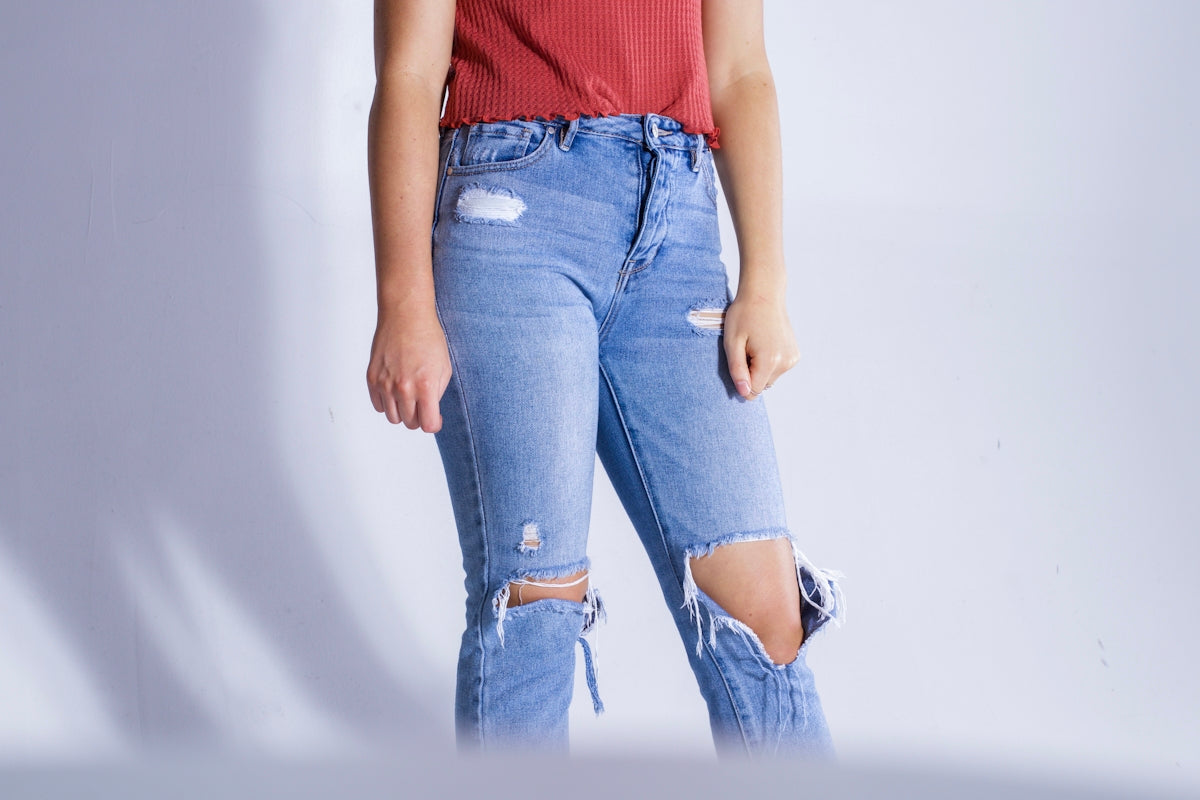 person wearing distressed jeans