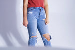 person wearing distressed jeans
